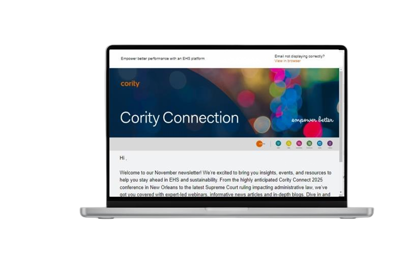 A laptop displaying the Cority Connection newsletter on its screen, featuring a dark blue header, colorful graphics, and a welcome message for the November edition—inviting you to subscribe for future newsletter updates.