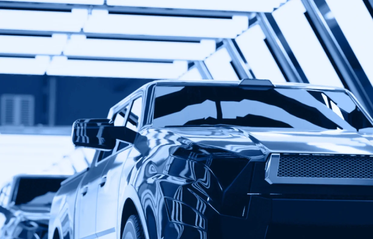 A blue-tinted, stylized image of a modern pickup truck parked indoors, with geometric ceiling lights reflecting on its shiny surface—an industry accordion of vehicles partially visible in the background.
