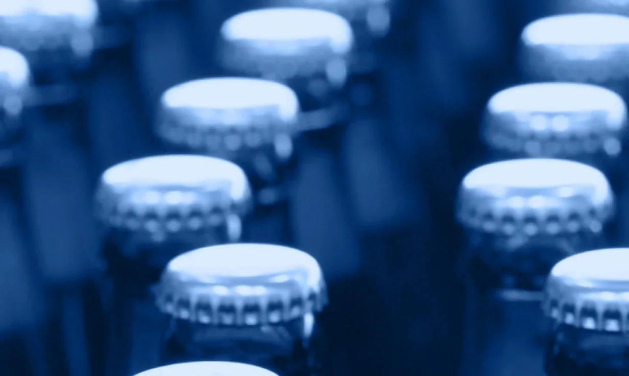 A close-up, blue-tinted image showing the tops of several glass bottles with metal caps, arranged in rows—perfectly capturing the organized rhythm of industry accordion-style storage for both home and professional settings.